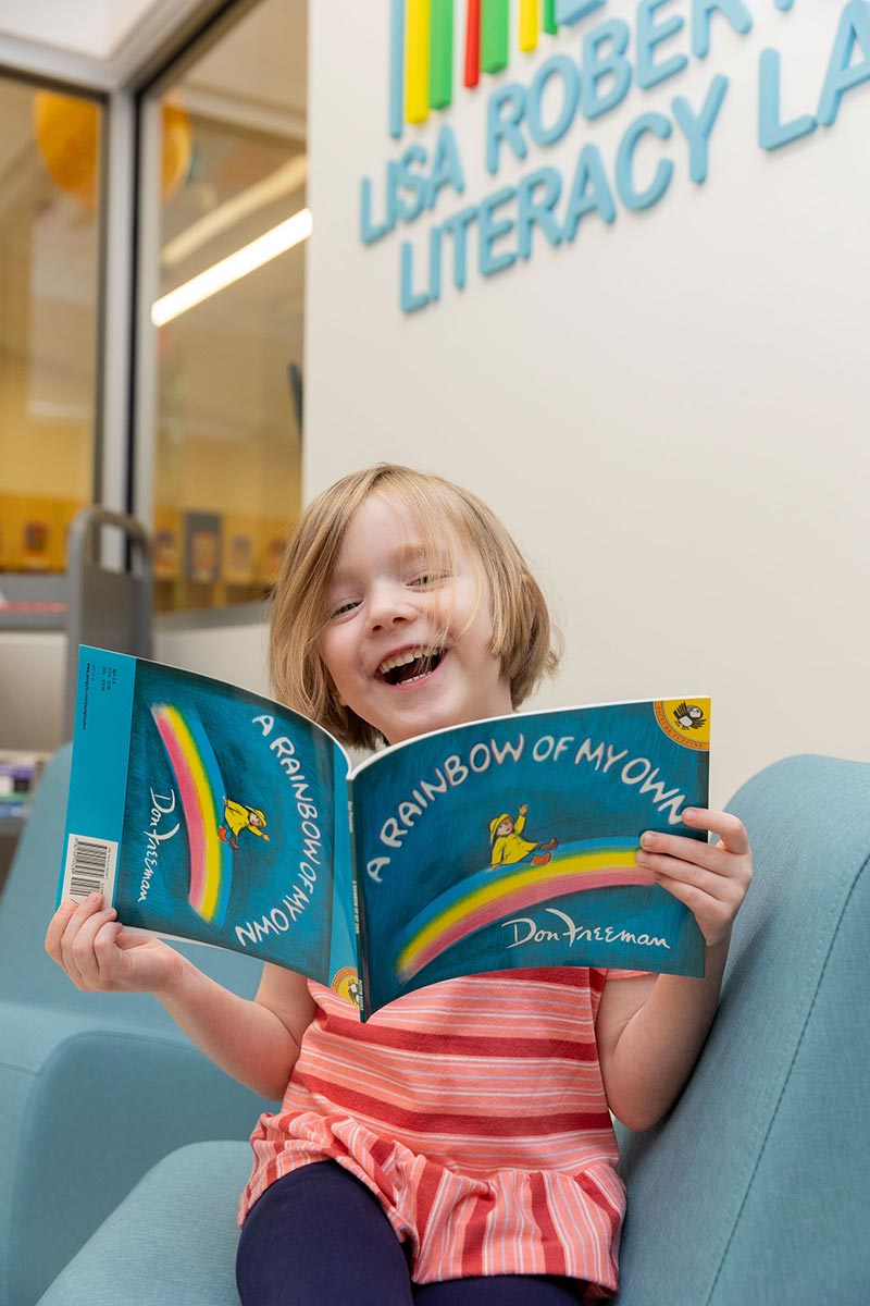 Child reading at Lisa Robertson Literacy Lab and Library