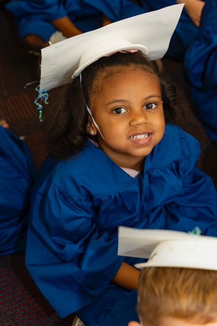 Smiling girl graduating at E3 School