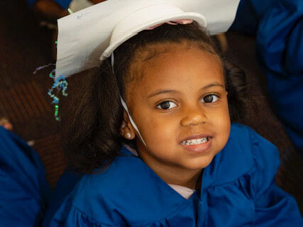 Smiling girl graduating at E3 School